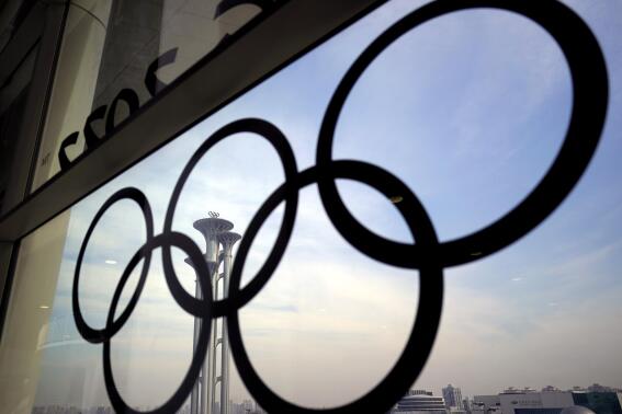 FILE - The Olympic rings are displayed at the main media center for the Beijing Winter Olympics on Tuesday, Jan. 18, 2022, in Beijing. (AP Photo/David J. Phillip, File)