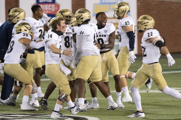The Akron Zips celebrate a missed field goal during an NCAA football game against the Ohio Bobcats on Nov. 10, 2020 in Athens, Ohio. (AP Photo/Emilee Chinn, File)