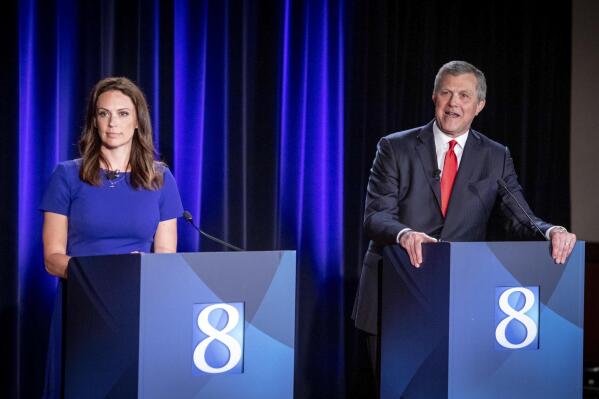 Michigan Republican candidates for governor Tudor Dixon, of Norton Shores and Kevin Rinke, of Bloomfield Township, appear at a debate in Grand Rapids, Mich., Wednesday, July 6, 2022. (Michael Buck/WOOD TV8 via AP)