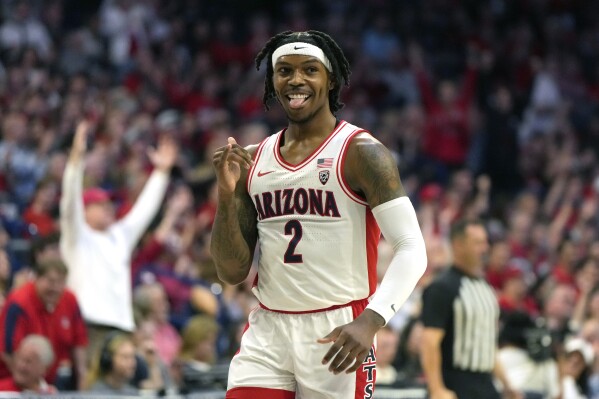 Arizona guard Caleb Love reacts after scoring against Washington during the first half of an NCAA college basketball game, Saturday, Feb. 24, 2024, in Tucson, Ariz. (AP Photo/Rick Scuteri)