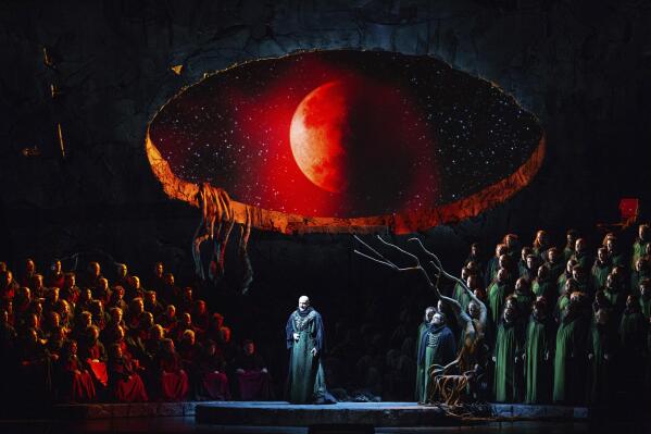 This image released by the Metropolitan Opera shows Bass Günther Groissböck, center, performing as Telramund during a dress rehearsal of director François Girard's production of Wagner's "Lohengrin" at the Metropolitan Opera on Feb. 18, 2023. (Marty Sohl/Metropolitan Opera via AP)