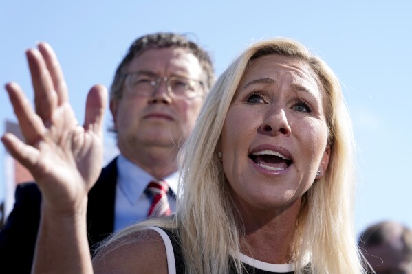 Rep. Marjorie Taylor Greene, R-Ga., joined by Rep. Thomas Massie, R-Ky., says she'll call a vote next week on ousting House Speaker Mike Johnson, R-La., during a news conference at the Capitol in Washington, Wednesday, May 1, 2024. Rep. Greene, a staunch ally of former President Donald Trump, is forcing her colleagues to choose sides after Democratic leaders announced they'd provide the votes to save the Republican speaker's job. (AP Photo/J. Scott Applewhite)