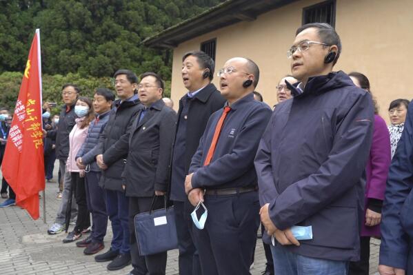 Students at the China Executive Leadership Academy recite a poem by revolutionary leader Mao Zedong in front of a wartime military outpost in Jinggangshan in southeastern China's Jiangxi Province, on April 9, 2021. As China celebrates the 100th anniversary of its 1921 founding, such trainings are part of efforts by President Xi Jinping's government to extend party control over a changing society. (AP Photo/Emily Wang)