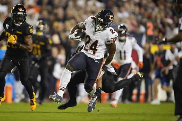 Chicago Bears running back Khalil Herbert (24) carries the ball against the Washington Commanders during the first half of an NFL football game, Thursday, Oct. 5, 2023, in Landover, Md. (AP Photo/Andrew Harnik)