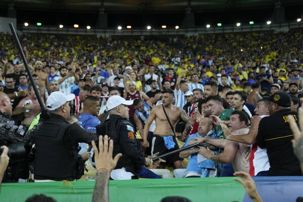 Police break up a fight between Brazilian and Argentinian fans that broke out prior to a qualifying soccer match for the FIFA World Cup 2026 between Brazil and Argentina at Maracana stadium in Rio de Janeiro, Brazil, Tuesday, Nov. 21, 2023.(AP Photo/Silvia Izquierdo)