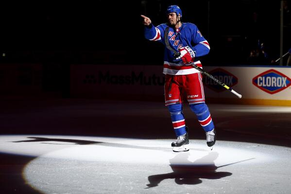 New York Rangers' Ryan Reaves points to a fan while being introduced as the first star of the team's NHL hockey game against the Toronto Maple Leafs on Wednesday, Jan. 19, 2022, in New York. The Rangers won 6-3. (AP Photo/John Munson)