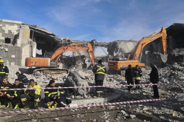 Emergency services clear the rubble of the house of Peshraw Dizayi that was hit in Iranian missile strikes in Irbil, Iraq, Tuesday, Jan. 16, 2024. Dizayi, a prominent local businessman, was killed in one of the Irbil strikes along with members of his family. (AP Photo/Julia Zimmermann/Metrography)