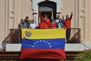 Venezuelan President Nicolas Maduro speaks to supporters from a balcony at Miraflores presidential palace during a rally marking the anniversary of the coup that overthrew dictator Marcos Perez Jim...