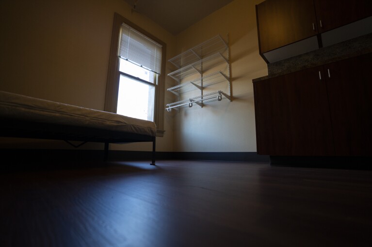 An empty bedroom is seen in an affordable housing building run by Central City Concern, a Portland-based homeless services nonprofit, on Friday, March 15, 2024, in Portland, Ore. The nonprofit leases more than 1,000 single room occupancy units, both subsidized and not, to people who are considered extremely low-income. It helps people struggling to access housing due to things like eviction histories and poor credit scores. (AP Photo/Jenny Kane)