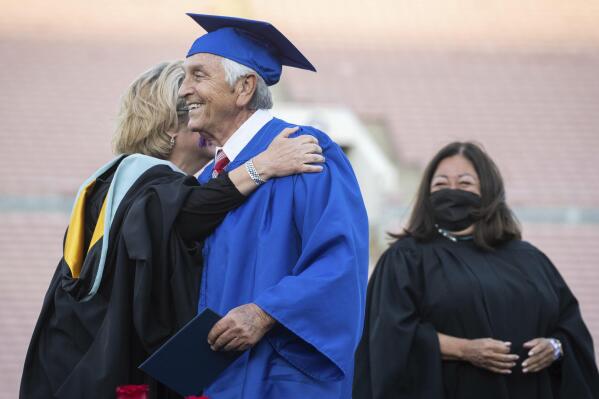 Ted Sams, 78, receives his original high school diploma during San Gabriel High School's graduation at the Rose Bowl on Friday, May 27, 2022, in Pasadena, Calif. (Sarah Reingewirtz/The Orange County Register via AP)
