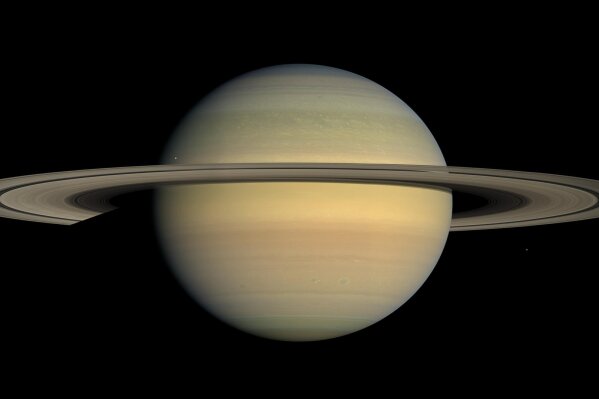 FILE - This July 23, 2008 file image made available by NASA shows the planet Saturn, as seen from the Cassini spacecraft. Twenty new moons have been found around Saturn, giving the ringed planet a total of 82, scientists said Monday, Oct. 7, 2019.   (NASA/JPL/Space Science Institute via AP, File)