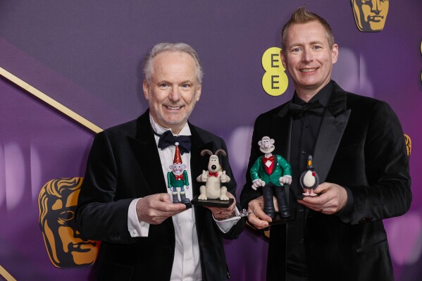 Nick Park, left, and Merlin Crossingham pose for photographers upon arrival at the 78th British Academy Film Awards, BAFTA's, in London, Sunday, Feb. 16, 2025. (Photo by Joel C Ryan/Invision/AP)