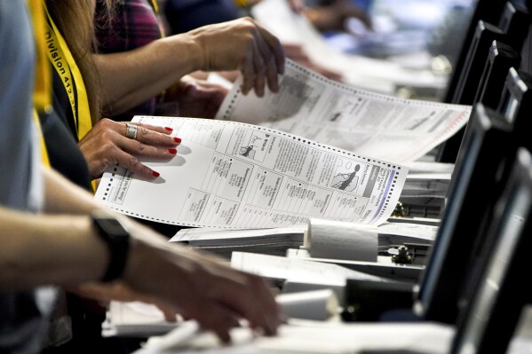 FILE – Election workers at the Allegheny County Election Division warehouse in Pittsburgh process ballots from the 2022 Pennsylvania primary on June 1, 2022. For the third time in less than eight months, a special election will decide control of the narrowly divided Pennsylvania House of Representatives and provide political reinforcements to either the commonwealth’s Democratic governor or the Republican-controlled Senate. (AP Photo/Gene J. Puskar, File)