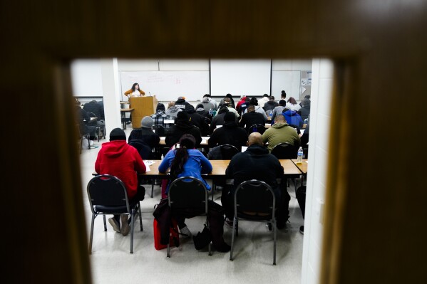 Philadelphia Police Academy applicants take a a reading entry exam in Philadelphia, Saturday, Feb. 24, 2024. The city has moved to lower requirements for the entry physical exam at its police academy as part of a broader effort nationally to reevaluate policies that keep law enforcement applicants out of the job pool amid a hiring crisis. (AP Photo/Matt Rourke)