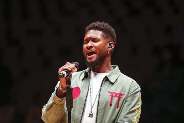 FILE - Singer Usher sings during a rehersal to honor the late Kobe Bryant prior to an NBA game against the Portland Trail Blazers at Staples Center Friday, Jan. 31, 2020, in Los Angeles. (AP Photo/Ringo H.W. Chiu, File)