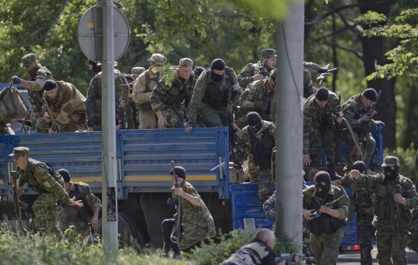 FILE - Pro-Russian gunmen take positions near the airport outside Donetsk, Ukraine, on Monday, May 26, 2014. Weeks after Russia annexed Ukraine's Crimea on March 18, 2014 , Moscow-backed separatists launched an uprising in eastern Ukraine, battling Kyiv's forces. The Kremlin denied supporting the rebellion with troops and weapons despite abundant evidence to the contrary. (AP Photo/Vadim Ghirda, File)