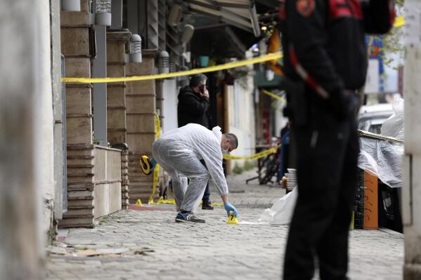 A policeman investigates the area outside Dine Hoxha mosque after a knife attack in Tirana, Albania, Monday, April 19, 2021.  Monday, April 19, 2021. Police say an Albanian man with a knife has attacked five people at a mosque in the capital of Tirana. A police statement said Rudolf Nikolli, 34, entered the Dine Hoxha mosque in downtown Tirana about 2:30 p.m. and wounded five people with a knife. (AP Photo)