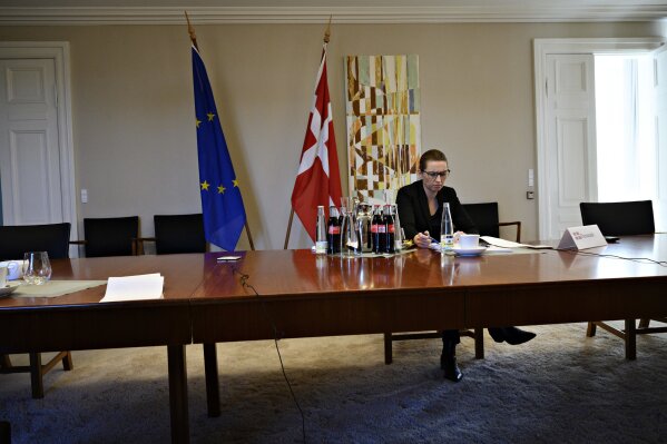 Danish Prime Minister Mette Frederiksen attends a video conference call with members of the European Council from her official residence Marienborg outside Copenhagen, Denmark, Thursday, March 26, 2020. European Union leaders are holding a summit aimed at containing the spread of the coronavirus and managing its devastating impact on their economies. The new coronavirus causes mild or moderate symptoms for most people, but for some, especially older adults and people with existing health problems, it can cause more severe illness or death. (Philip Davali/Scanpix via AP)