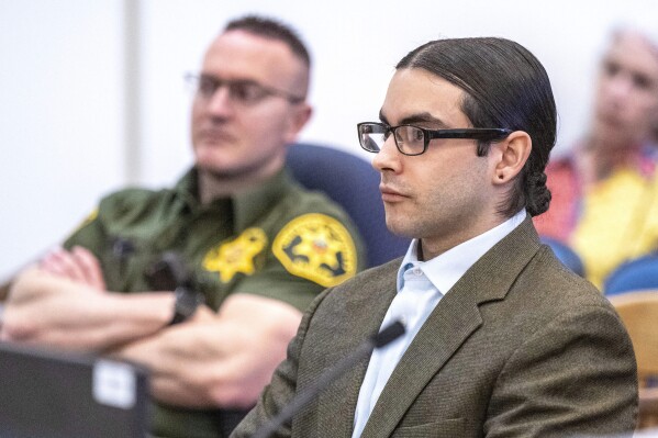 Marcus Eriz, right, sits in court during his sentencing, Friday, April 12, 2024, in Santa Ana, Calif. Eriz was sentenced Friday to 40 years to life for the fatal shooting of a 6-year-old boy who was riding in the back of his mother's car on the freeway, prosecutors said. (Mark Rightmire/The Orange County Register via AP)