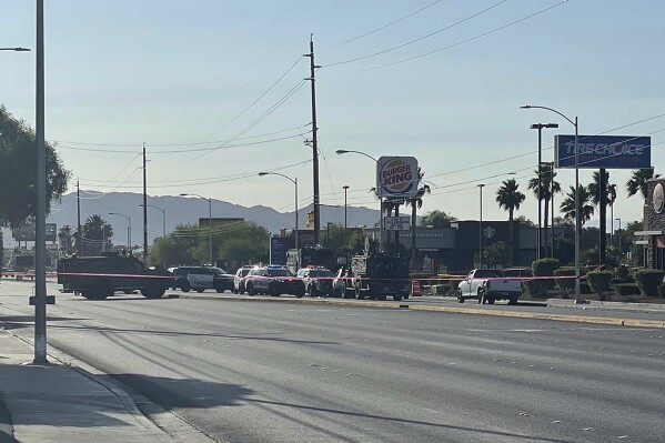 Police work in the 4400 block of East Charleston Boulevard in Las Vegas, Friday, June 23, 2023. Authorities in Nevada say a woman’s 911 text that she'd been kidnapped led to the shooting by Las Vegas police of an armed suspect in an SUV with at least two other people inside. (Sabrina Schnur/Las Vegas Review-Journal via AP)