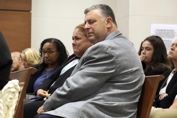 Jennifer and Tony Montalto listen as Dr. Marlin Osbourne, assistant medical examiner for Palm Beach County, Fla., testify about the gunshot wounds their daughter Gina Montalto sustained in the mass shooting during the penalty phase of Marjory Stoneman Douglas High School shooter Nikolas Cruz's trial in Fort Lauderdale, Fla., July 26, 2022. Gov. Ron DeSantis and Florida lawmakers are proposing to make it easier to send convicts to death row by eliminating the requirement that juries be unanimous on capital punishment. (Mike Stocker/South Florida Sun Sentinel via AP, Pool, File)