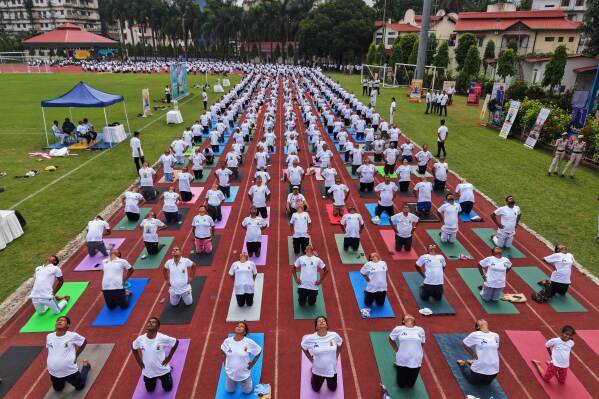 Indians perform yoga during an event to mark International Day of Yoga at a playground in Guwahati, India, Saturday, June 21, 2025. (AP Photo/Anupam Nath)