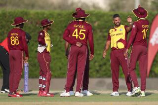 West Indies' Ravi Rampaul, second right, is congratulated by teammates after dismissing Pakistan's Mohammad Rizwan during the Cricket Twenty20 World Cup warm-up match between Pakistan and the West Indies in Dubai, UAE, Monday, Oct. 18, 2021. (AP Photo/Aijaz Rahi)