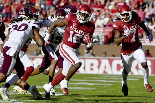 Arkansas receiver Treylon Burks (16) tries to get past Mississippi State defender Decamerion Richardson (30) as he runs the ball during the first half of an NCAA college football game Saturday, Nov. 6, 2021, in Fayetteville, Ark. (AP Photo/Michael Woods)