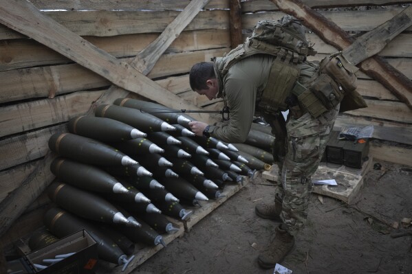 A Ukrainian officer of the 92nd separate assault brigade inspects ammunition in a shelter on the frontline near Vovchansk, Kharkiv region, Ukraine, Monday, Oct. 28, 2024. (AP Photo/Efrem Lukatsky)