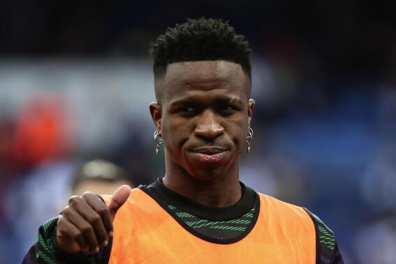 Real Madrid's Vinicius Junior gestures as he is warming up prior a Spanish La Liga soccer match between Real Madrid and Valladolid at the Santiago Bernabeu stadium in Madrid, Spain, Sunday, April 2, 2023. (AP Photo/Pablo Garcia)
