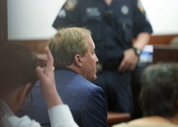 Suspended Texas Attorney General Ken Paxton sits as he makes an appearance in the Harris County Courthouse on Thursday, Aug. 3, 2023 in Houston. Paxton's years-delayed trial on securities fraud charges will have to wait until his separate impeachment trial is concluded, lawyers and the judge in the case said Thursday. (Elizabeth Conley/Houston Chronicle via AP)