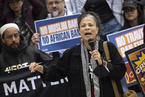 Melina Abdullah of Black Lives Matter delivers a speech during a protest against new travel ban announced last week by President Donald Trump, at the Tom Bradley International Terminal at Los Angeles International Airport, Monday, June 9, 2025, in Los Angeles. (AP Photo/Etienne Laurent)