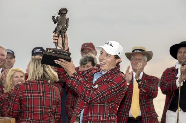 Matt Fitzpatrick, of England, holds the championship trophy after a three-hole playoff during the final round of the RBC Heritage golf tournament, Sunday, April 16, 2023, in Hilton Head Island, S.C. (AP Photo/Stephen B. Morton)