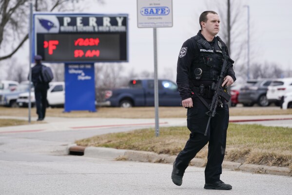 Police respond to a shooting at Perry High School in Perry, Iowa, Thursday, Jan. 4, 2024. Authorities said a 17-year-old student with a shotgun and a handgun opened fire at the small-town high school. (AP Photo/Andrew Harnik)