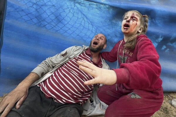 Reactie van gewonde Palestijnen na een Israëlische aanval op Al-Zawaida, centrale Gazastrook, donderdag 28 december 2023. (AP Photo/Mohammed Asad)