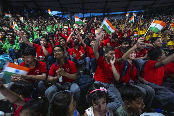 Schoolchildren celebrate the successful landing of spacecraft Chandrayaan-3 on the moon, in a school in Guwahati, India, Wednesday, Aug. 23, 2023. (AP Photo/Anupam Nath)