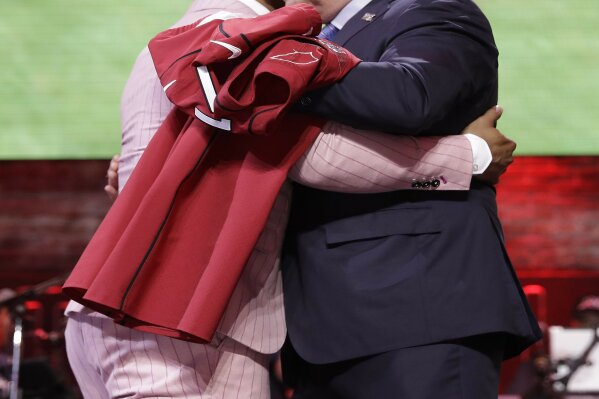 FILE - In this April 25, 2019, file photo, Oklahoma quarterback Kyler Murray embraces NFL Commissioner Roger Goodell after the Arizona Cardinals selected Murray in the first round at the NFL football draft in Nashville, Tenn. NFL vice president Troy Vincent has sent a letter to several prospects inviting them to participate “live” in the NFL draft in three weeks. In recent drafts, first-round selections were announced by Commissioner Goodell. Then followed hugs involving players and Goodell — some of them comical — and photo sessions with the players wearing team ball caps or even showing off team jerseys. This year, with all public events at the planned site of Las Vegas canceled and the draft set to proceed remotely, players will likely be at their homes when their names are called. (AP Photo/Mark Humphrey, File)