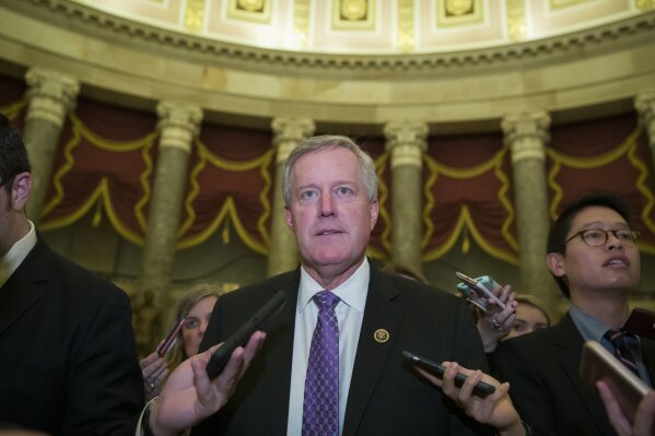 
              FILE - In this Dec. 21, 2018 file photo, Rep. Mark Meadows, R-N.C., chairman of the House Freedom Caucus, walks as he speaks with reporters as they work to pass a bill that would pay for President Donald Trump's border wall and avert a partial government shutdown, on Capitol Hill in Washington.  Meadows backed the president's decision to reopen the government and said if Congress won't help, Trump should use whatever executive authority he has to build a wall. (AP Photo/Alex Brandon)
            