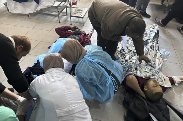 Palestinians wounded in an Israeli strike while waiting for humanitarian aid on the beach in Gaza City are treated in Shifa Hospital in Gaza City, Feb. 29, 2024. (AP Photo/Mahmoud Essa, File)