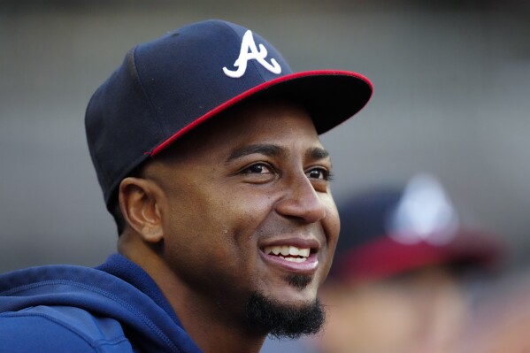 Injured Atlanta Braves shortstop Ozzie Albies sits in the dugout before a baseball game against the Miami Marlins Wednesday, April 24, 2024, in Atlanta. (AP Photo/John Bazemore)
