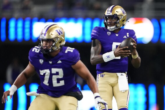 Washington quarterback Michael Penix Jr. (9) looks for a receiver from behind offensive lineman Parker Brailsford (72) during the first half of the team's NCAA college football game against California on Saturday, Sept. 23, 2023, in Seattle. (AP Photo/Lindsey Wasson)