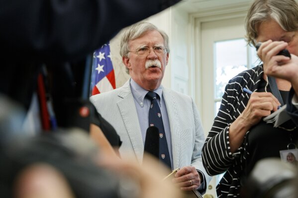 FILE - In this July 19, 2019, file photo, then-National security adviser John Bolton speaks at the request of President Donald Trump during a photo opportunity in the Oval Office of the White House in Washington. Top officials in the White House were aware in early 2019 of classified intelligence indicating Russia was secretly offering bounties to the Taliban for the deaths of Americans, a full year earlier than has been previously reported. That's according to U.S. officials with direct knowledge of the intelligence. Bolton also told colleagues he briefed Trump on the intelligence assessment in March 2019.   (AP Photo/Alex Brandon, File)