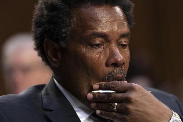 Garnell Whitfield, Jr., of Buffalo, N.Y., whose mother, Ruth Whitfield, was killed in the Buffalo Tops supermarket mass shooting, wipes away tears as he testifies at a Senate Judiciary Committee hearing on domestic terrorism, Tuesday, June 7, 2022, on Capitol Hill in Washington. (AP Photo/Jacquelyn Martin)
