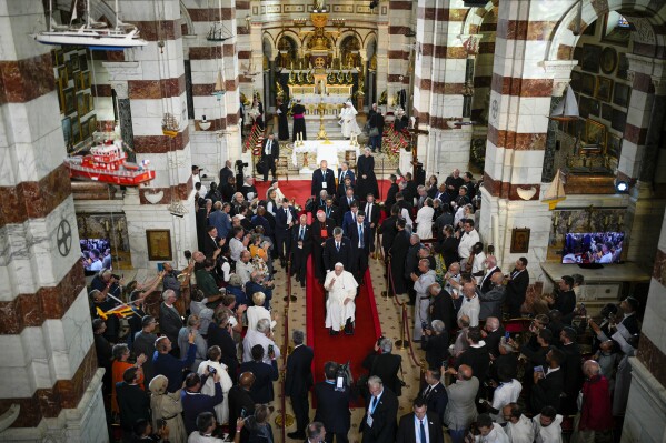 Pope Francis leaves the Notre Dame de la Garde Basilica at the end of a Marian prayer with the diocesan clergy, in Marseille, France, Friday, Sept. 22, 2023. Francis, during a two-day visit, will join Catholic bishops from the Mediterranean region on discussions that will largely focus on migration. (AP Photo/Daniel Cole)