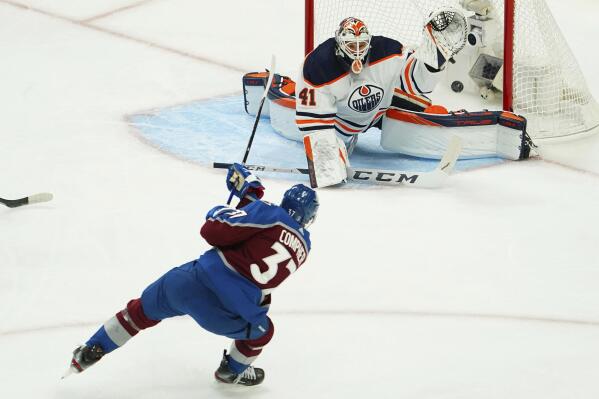 Colorado Avalanche left wing J.T. Compher (37) scores a goal against Edmonton Oilers goaltender Mike Smith (41) during the first period in Game 1 of the NHL hockey Stanley Cup playoffs Western Conference finals Tuesday, May 31, 2022, in Denver. (AP Photo/Jack Dempsey)