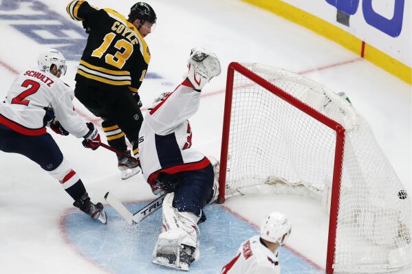 Boston Bruins' Charlie Coyle (13) scores on Washington Capitals goalie Ilya Samsonov (30) during the third period in Game 4 of an NHL hockey Stanley Cup first-round playoff series Friday, May 21, 2021, in Boston. (AP Photo/Michael Dwyer)