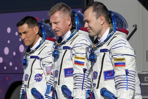 FILE - From left, NASA astronaut Frank Rubio, Roscosmos cosmonauts Sergey Prokopyev and Dmitri Petelin, crew members of the mission to the International Space Station (ISS), walk to the rocket prior the launch of Soyuz-2.1 rocket, at the Russian leased Baikonur cosmodrome, Kazakhstan, Wednesday, Sept. 21, 2022. The three are expected to return to Earth on Wednesday, Sept; 27, 2023, after being stuck in space for just over a year after their original capsule was hit by space junk. The 180-day mission turned into a 371-day stay. (AP Photo/Dmitri Lovetsky, Pool, File)