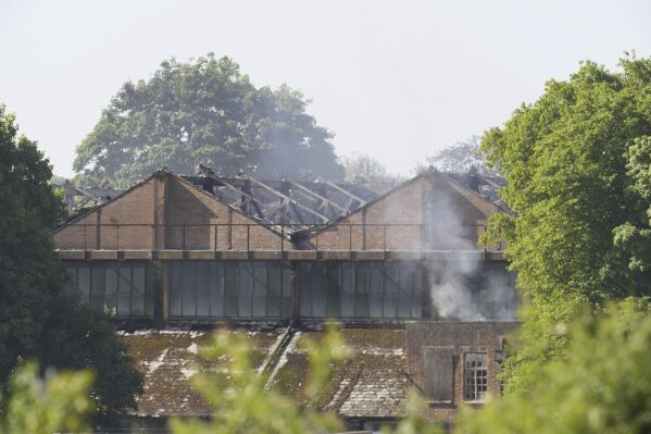 Smoke rises from a damaged building following a fire that broke out on Thursday at Bicester Motion in Oxfordshire, Friday, May 16, 2025. ( Andrew Matthews/PA via AP)