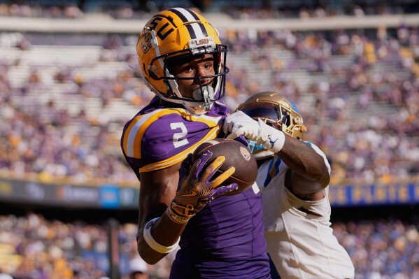 LSU wide receiver Kyren Lacy (2) tries to pull in a pass in the end zone as he is covered by UCLA defensive back Jaylin Davies in the second half of an NCAA college football game in Baton Rouge, La., Saturday, Sept. 21, 2024. (AP Photo/Gerald Herbert, File)