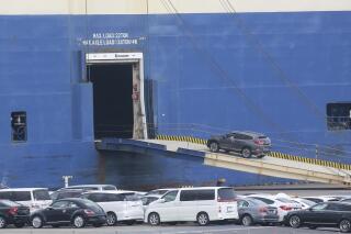 Cars for export are loaded onto a cargo ship at a port in Yokohama, on Nov. 2, 2021. Japan’s economy grew at an annual pace of 5.4% in October-December, boosted by improved consumer spending and exports, the government said Tuesday, Feb. 15, 2022. (AP Photo/Koji Sasahara, File)